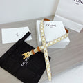 CELINE TRIOMPHE BELT 18MM REVERSIBLE IN WHITE CALFSKIN WITH GOLD MONOGRAM PRINT AND BROWN CALFSKIN WITH GOLD BUCKLE